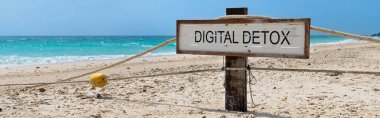 Old wooden sign with text digital detox on tropical beach clipart