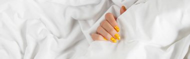 Manicured womans with trendy nail design on bed clipart