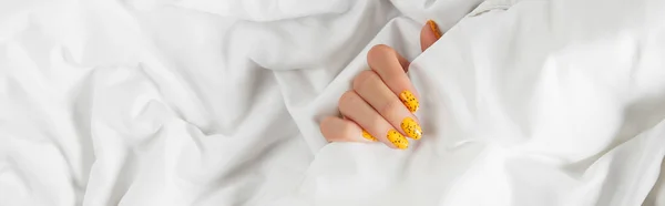 Manicured womans with trendy nail design on bed — Stock Photo, Image