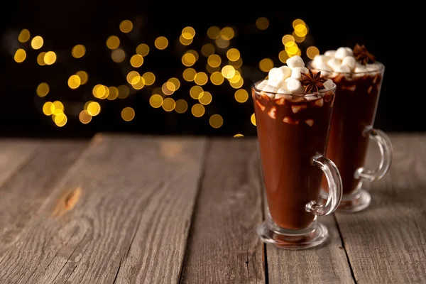 Hot chocolate with marshmallow on wooden table with copy space — стоковое фото