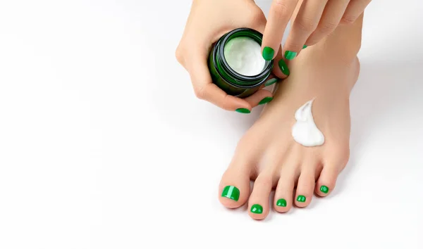 Woman apply cream on feet on white background —  Fotos de Stock