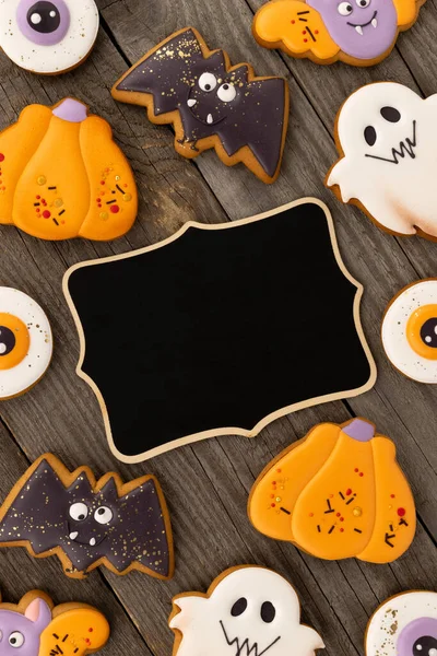 Deliciosos biscoitos caseiros de Halloween de várias formas na velha mesa de madeira — Fotografia de Stock