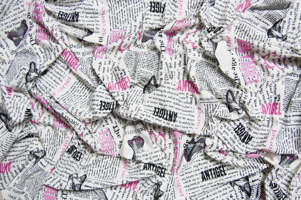 White fabric printed with text pattern, black and pink abstract font. The patterned print, complete, and enriches the lycra draped.