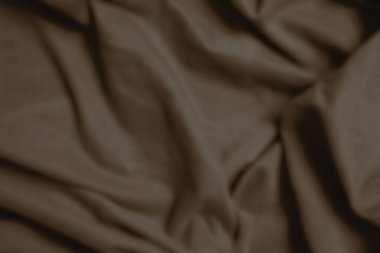 Kahverengi kumaş likra, dalgalı ve bulanık.