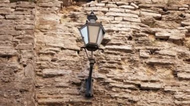 Vintage lamp or lantern on the stone wall