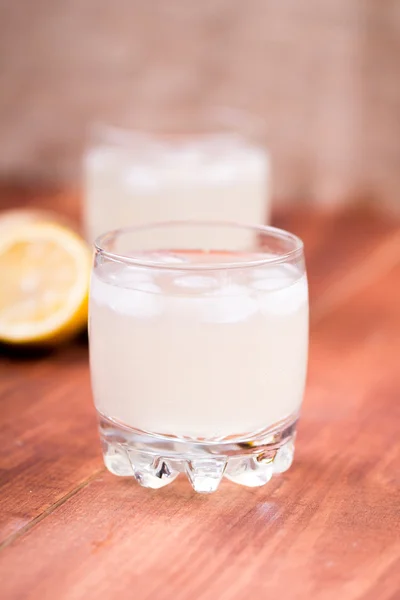 Ginger drink with ice and a lemon