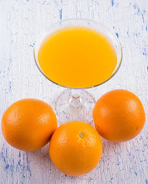 Orange juice and oranges Royalty Free Stock Photos