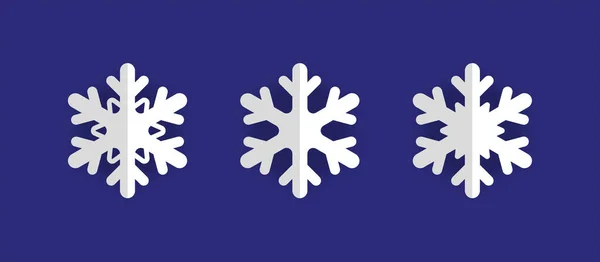 Üç beyaz Noel kağıdından oluşan vektör seti koyu mavi arka planda gölgeli üç boyutlu kar taneleri kesiyor. Yeni yıl ve Noel tasarım unsurları