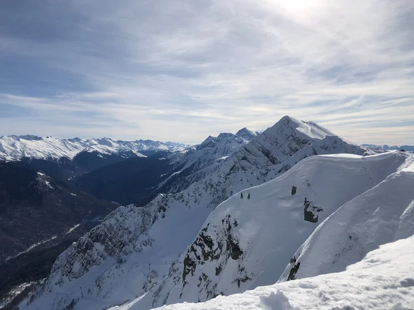 Top view of mountain peaks on a winter sunny day