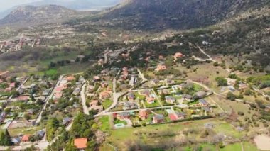 Spectacular establishing shot of village in mountainous area located in valley on sunny day in summer