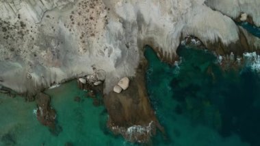 Spectacular aerial view of calm sea with clear turquoise water and rocky coastline