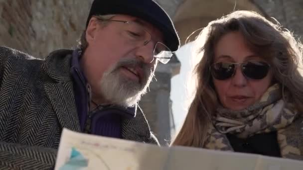 Low Angle Travelling Senior Couple Reading Map Discussing Route While — Stock Video