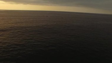 Spectacular drone view of boats floating on calm water of sea at sundown