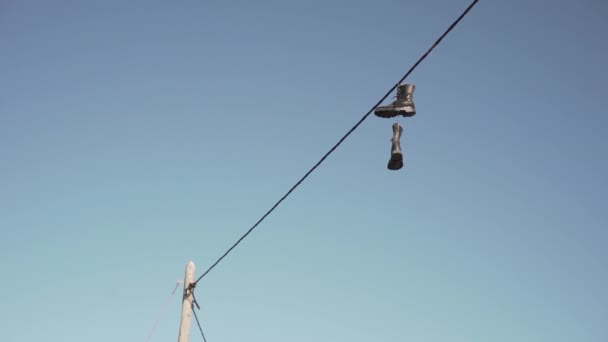 Pair Old Boots Hanging Electronic Wire — Stock Video