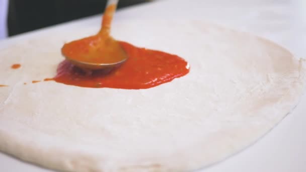 Faceless Chef Spreading Aromatic Tomato Sauce Dough Big Metal Spoon — Video Stock