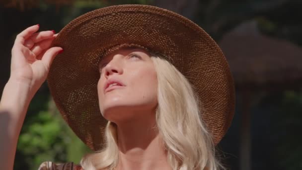 Serious Young Blond Haired Slim Female Tourist Touching Hat While — Stock Video