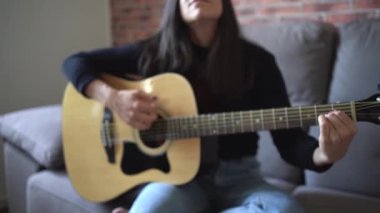 Evde gitar çalan kadın.