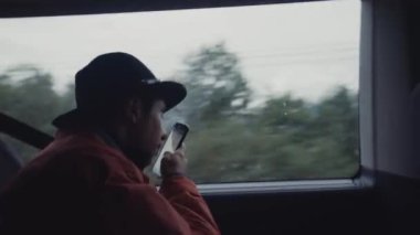 Man using phone while riding in train