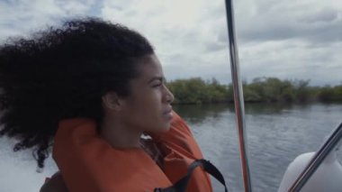 Suyun yanındaki teknede genç bir bayan