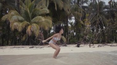 Genç bayan deniz kenarında eğleniyor.