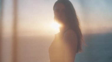 Huzurlu bir Gran Canaria plajında nefis bir gün batımına karşı zarif bir şekilde duran genç bir kadın, bir sahil akşamının güzelliğini ve huzurunu yakalıyor..