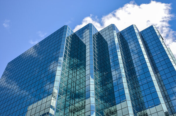 The glass skyscrapper reflecting the clouds in Ottawa downtown