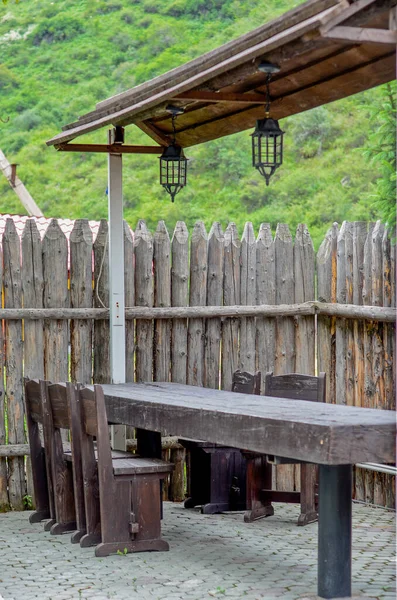 view of the backyard with wooden table near old  fence