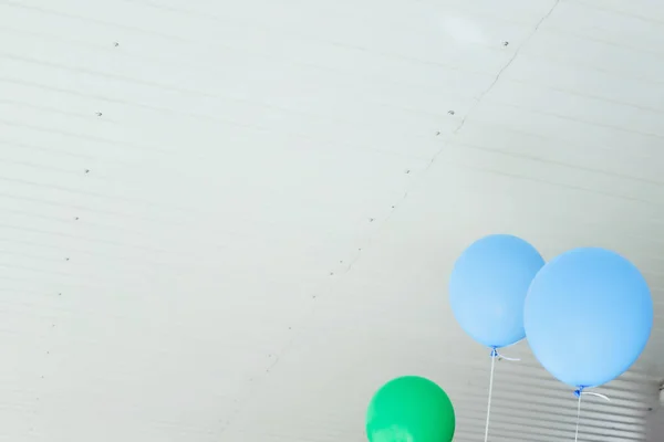 A bunch of multicolored balloons with helium on a white background, blu