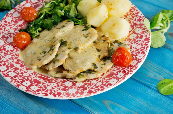 Closeup of Roast turkey with potatoes and rucola, tomatoes on blue wooden table — Stock Photo, Image