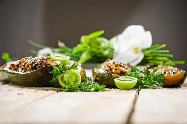 Baked stuffed eggplant with minced meat on rustic wooden table