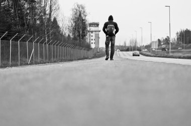 View of young man walking on road near airport
