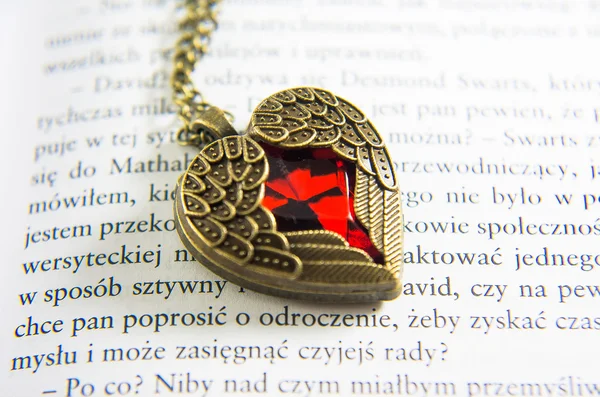 Golden necklace with pink heart on chain. Valentine's day gift