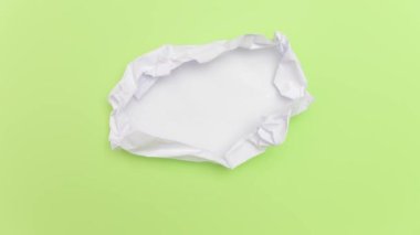 Hareket Animasyonunu Durdur _ Yeşil arkaplanda açılmakta olan beyaz kağıt top