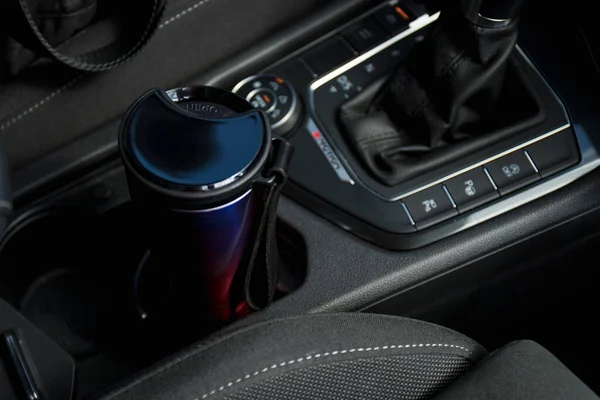 Eco cup with coffee in holder inside car. High quality photo