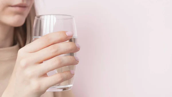 Young woman drinking glass of water. High quality photo