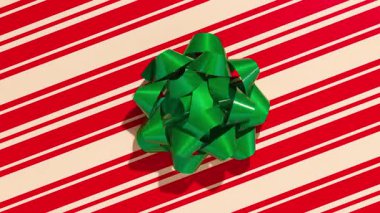 Unwrapping gift revealing a green screen - Stop Motion Animation - Green bow on Christmas wrapping paper