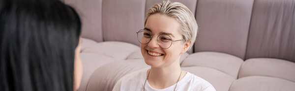 happy young lesbian woman looking at blurred girlfriend, banner