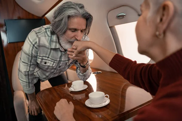 Mature Man Kissing Hand Wife Cups Private Plane — Stock Photo, Image