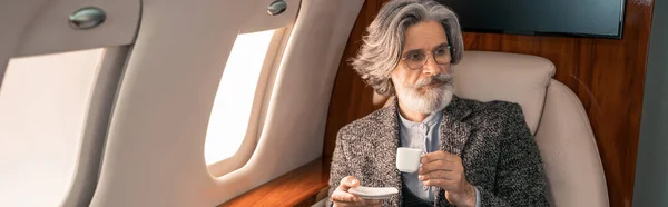 Mature Man Holding Coffee Private Plane Banner — Stock Photo, Image