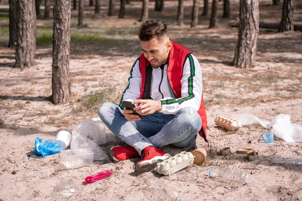 Cheerful Man Crossed Legs Sitting Using Smartphone Trash Ground — Stock Photo, Image