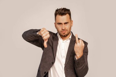 dissatisfied man showing finger with wedding ring and dislike sign isolated on grey