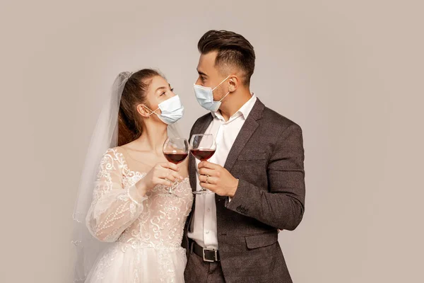 Newlyweds Safety Masks Looking Each Other While Clinking Wine Glasses — Stockfoto