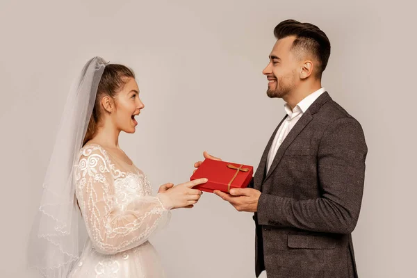 Side View Happy Man Presenting Gift Amazed Bride Isolated Grey — Stock Photo, Image