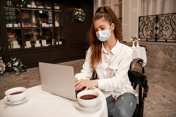 Young Woman Medical Mask Working Laptop Cafe —  Fotos de Stock