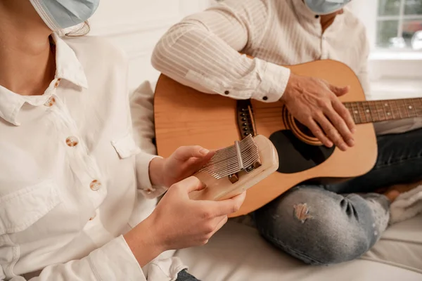 Cropped View Couple Medical Masks Playing Musical Instruments Home — Fotografia de Stock