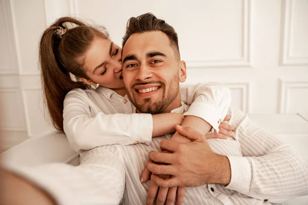 Pretty Woman Biting Ear Cheerful Man While Having Fun Home — Stok fotoğraf