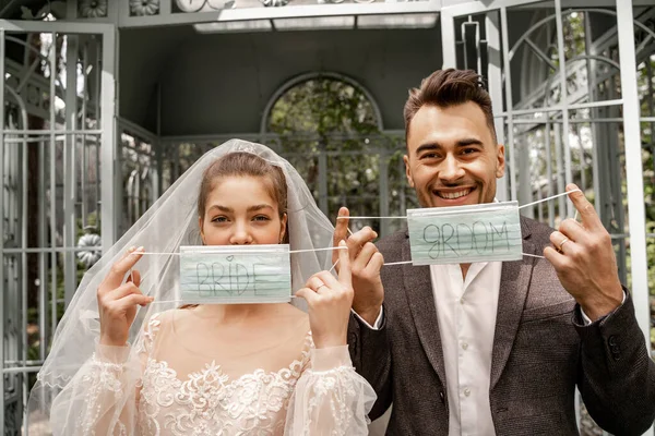 Happy Man Woman Holding Medical Masks Bride Groom Lettering — Fotografia de Stock