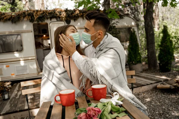Man Medical Mask Kissing Girlfriend Cups Coffee Outdoors — Stock fotografie