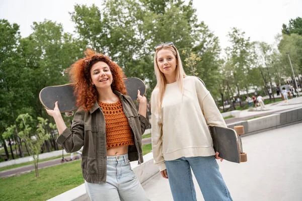 Mujeres Jóvenes Con Patinetas Mirando Cámara Aire Libre —  Fotos de Stock