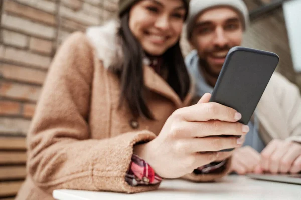 Happy blurred couple looking at smartphone — Stock Photo